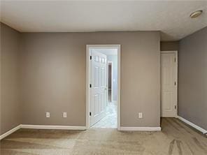 unfurnished room with baseboards