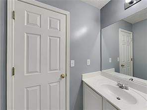 bathroom with vanity and a textured ceiling