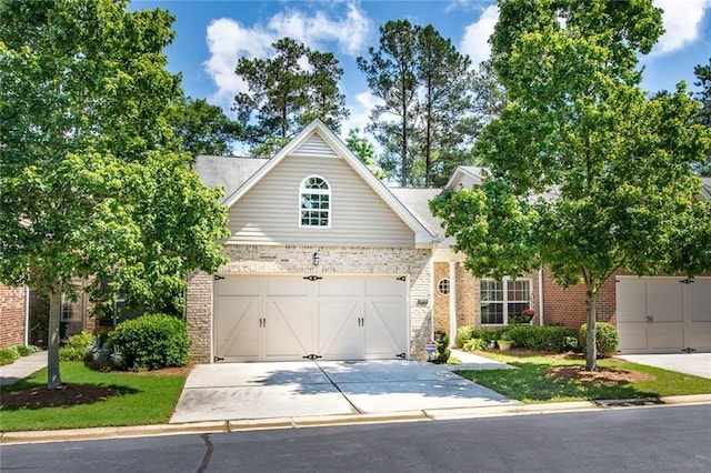 view of front of house with brick siding and driveway