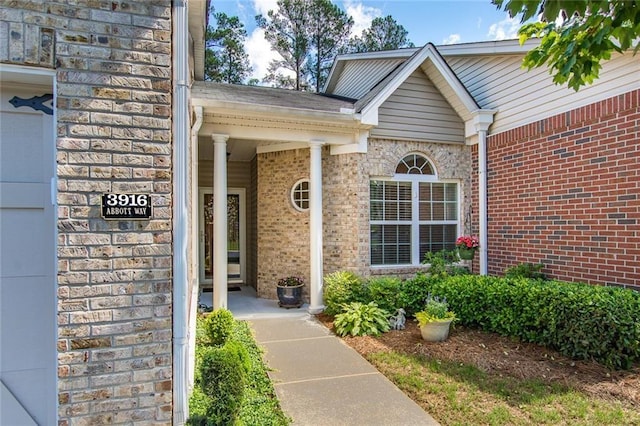 entrance to property featuring brick siding