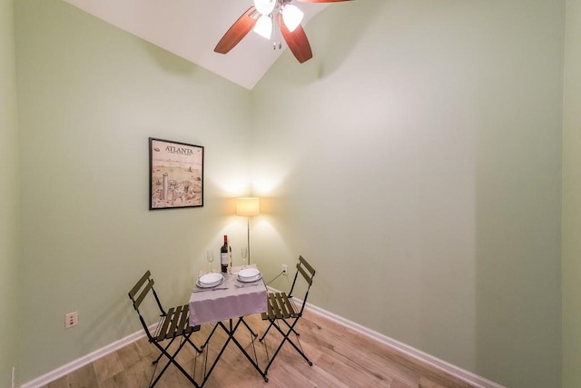 office featuring vaulted ceiling, baseboards, light wood finished floors, and ceiling fan