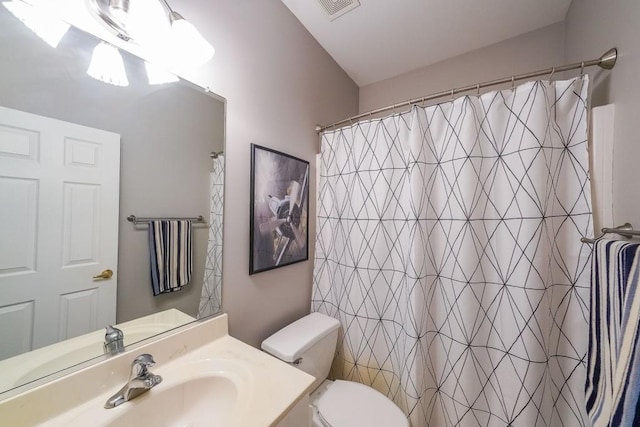 bathroom with visible vents, curtained shower, toilet, and vanity