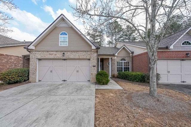 view of front of house with brick siding, concrete driveway, and an attached garage