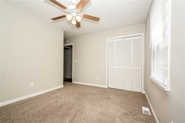 6194 Golden Meadow Ct, Riverdale, GA 30296 - unfurnished bedroom featuring carpet flooring, a closet, and ceiling fan