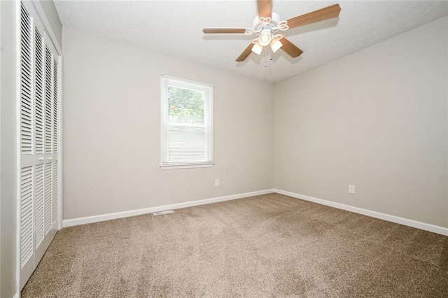 6194 Golden Meadow Ct, Riverdale, GA 30296 - unfurnished bedroom with a closet, carpet flooring, and a ceiling fan