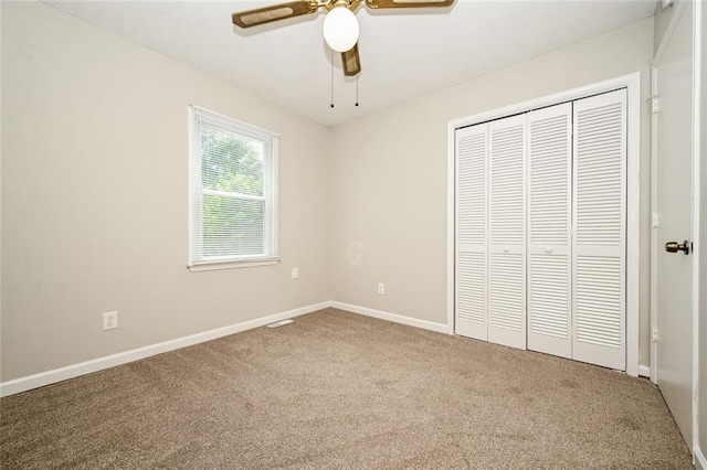 6194 Golden Meadow Ct, Riverdale, GA 30296 - unfurnished bedroom with carpet flooring, a closet, and a ceiling fan