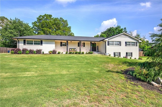 ranch-style home with fence and a front yard