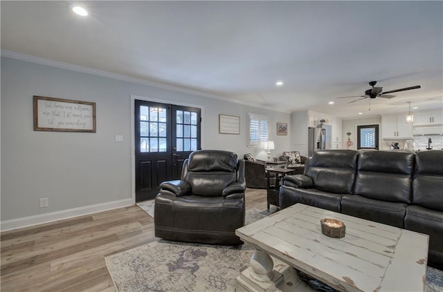 living room with crown molding, recessed lighting, light wood-style flooring, and a ceiling fan
