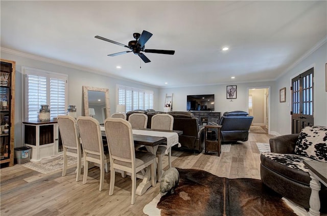 dining area with light wood finished floors, a ceiling fan, baseboards, recessed lighting, and ornamental molding