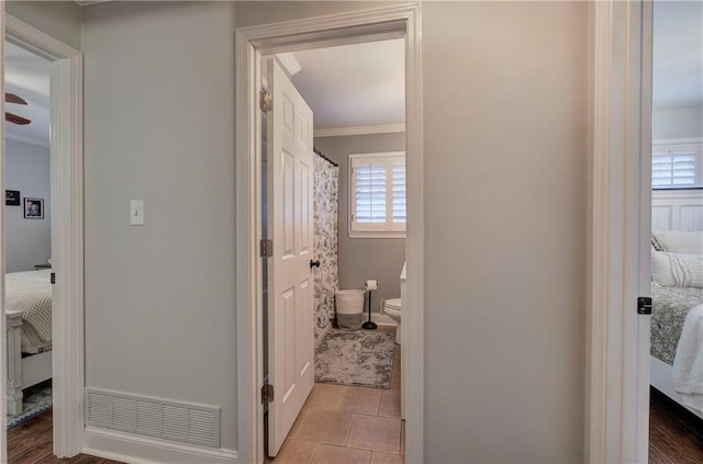 full bathroom featuring visible vents, tile patterned flooring, toilet, connected bathroom, and ornamental molding
