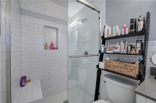 bathroom with toilet and a stall shower