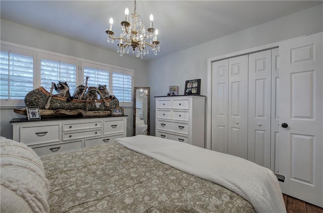 bedroom featuring a closet, dark wood-style floors, and a chandelier