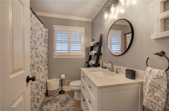 bathroom with visible vents, crown molding, vanity, baseboards, and toilet