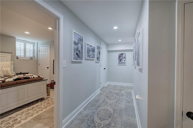 corridor featuring recessed lighting and baseboards