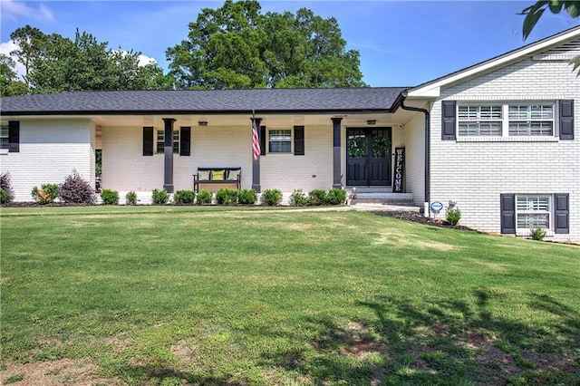 single story home with brick siding, a front lawn, and covered porch