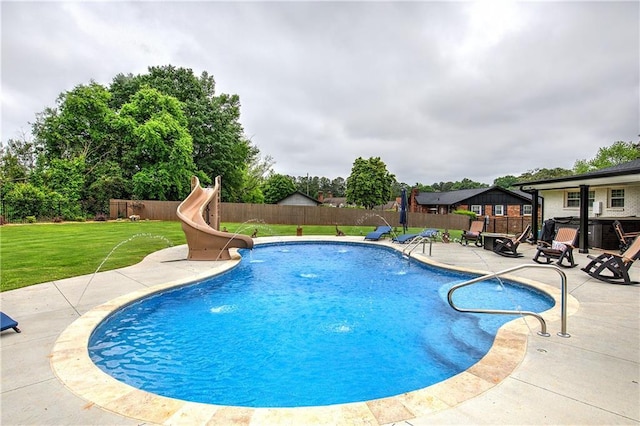 view of pool featuring a patio area, a fenced in pool, a fenced backyard, a yard, and a water slide