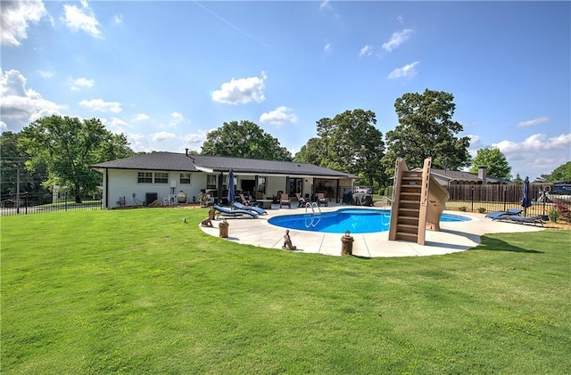 view of swimming pool with fence, a fenced in pool, a yard, and a patio area