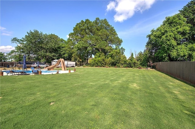 view of yard featuring fence private yard and a fenced in pool