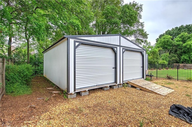 view of outbuilding with fence and an outbuilding