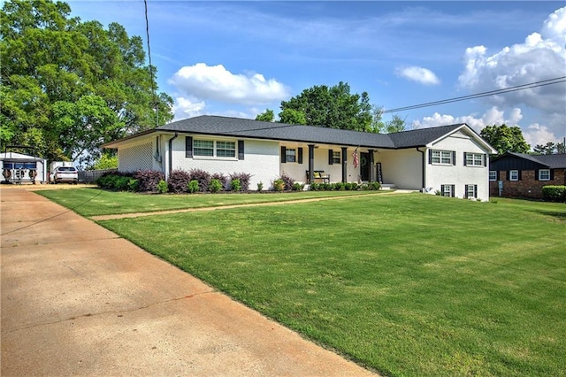 single story home featuring brick siding, a front lawn, and covered porch