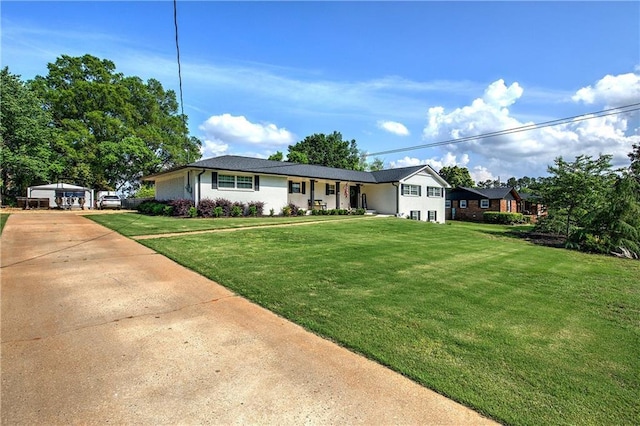 ranch-style home with an outbuilding and a front yard