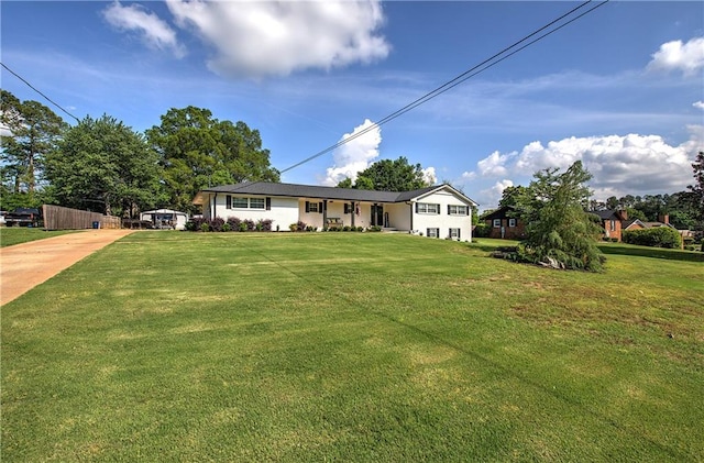view of front facade featuring concrete driveway and a front lawn