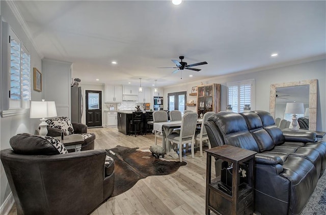 living room featuring crown molding, recessed lighting, ceiling fan, and light wood-type flooring
