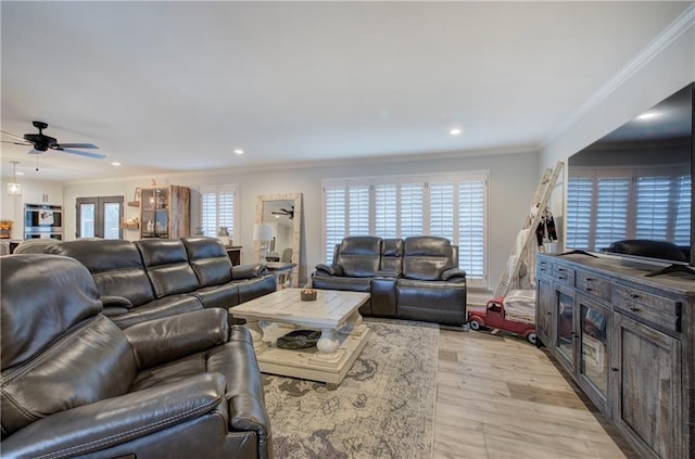 living area with recessed lighting, ornamental molding, a ceiling fan, and light wood-type flooring