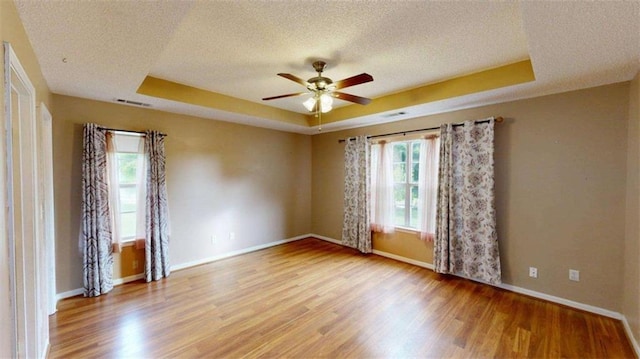 210 Overview Ct, Villa Rica, GA 30180 - unfurnished room featuring a tray ceiling, a textured ceiling, a ceiling fan, wood finished floors, and baseboards