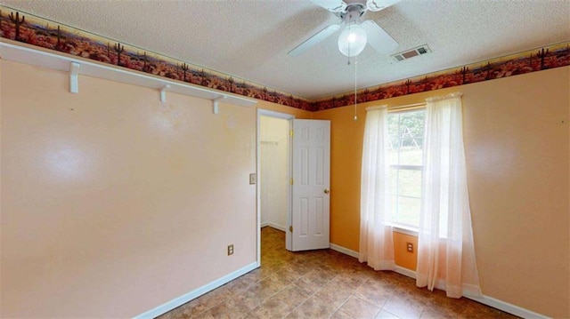 210 Overview Ct, Villa Rica, GA 30180 - empty room with a textured ceiling, baseboards, a ceiling fan, and light tile patterned flooring