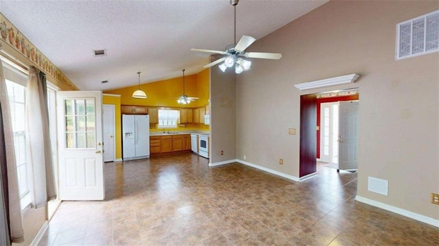 210 Overview Ct, Villa Rica, GA 30180 - kitchen with white refrigerator with ice dispenser, ceiling fan, light countertops, plenty of natural light, and high vaulted ceiling