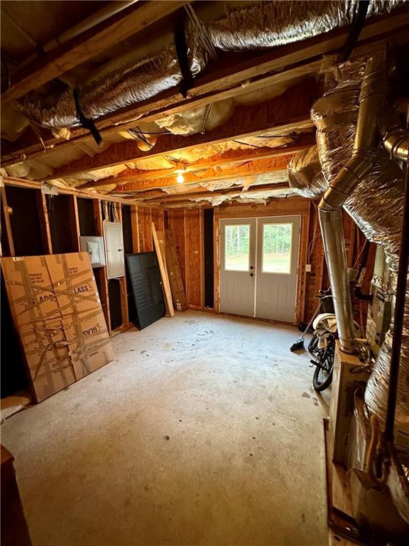 unfinished attic featuring electric panel