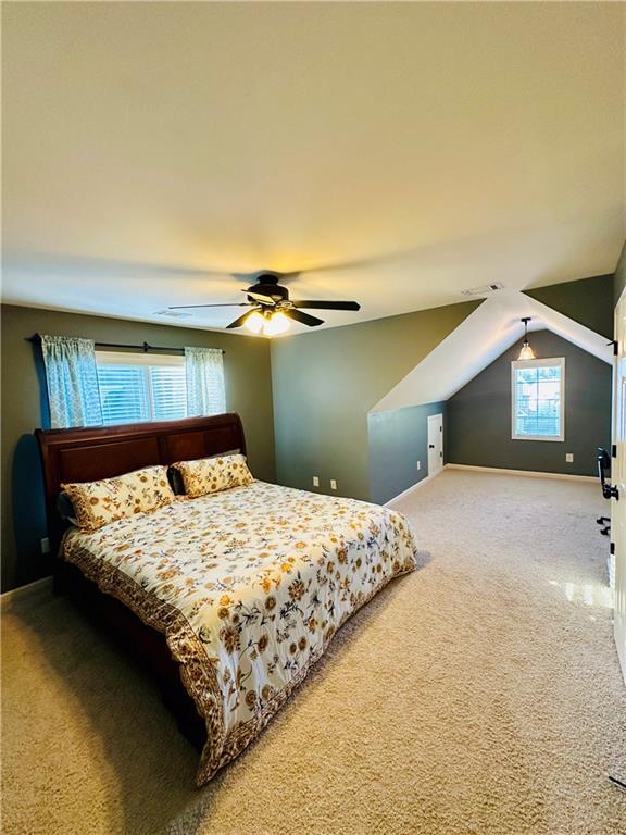 bedroom featuring ceiling fan, baseboards, carpet, and vaulted ceiling