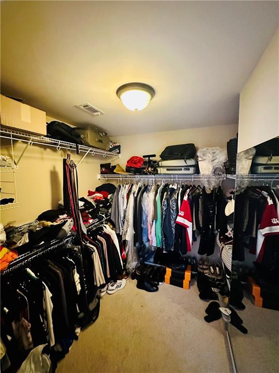 spacious closet featuring visible vents and carpet