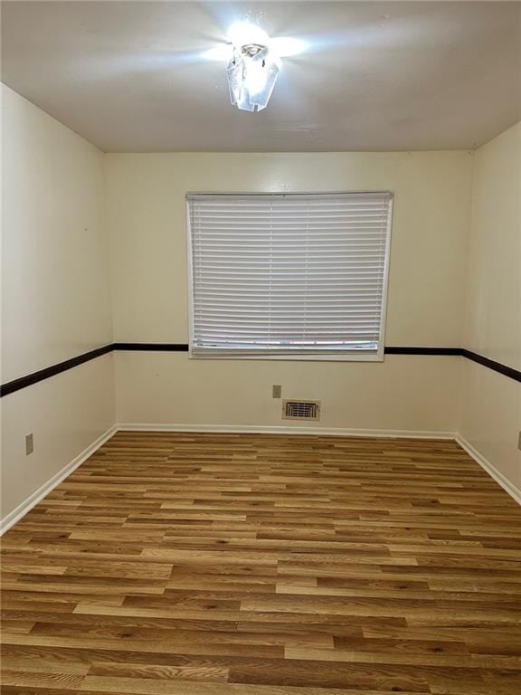 unfurnished room featuring wood-type flooring