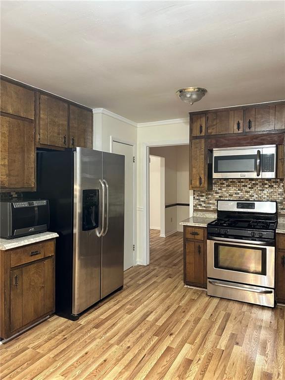 kitchen with dark brown cabinetry and stainless steel appliances