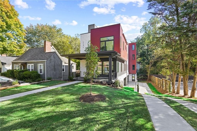 contemporary house featuring a front lawn