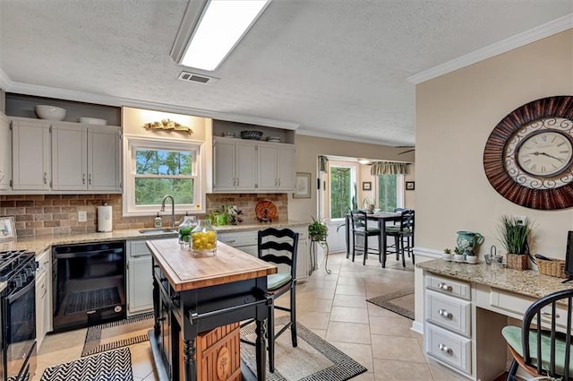 kitchen with backsplash, dishwasher, gas range, sink, and ornamental molding