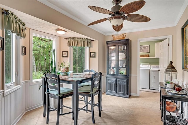 dining room featuring crown molding, a healthy amount of sunlight, ceiling fan, and separate washer and dryer