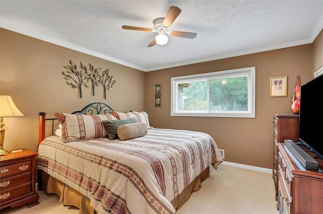 carpeted bedroom with a textured ceiling, ceiling fan, and ornamental molding