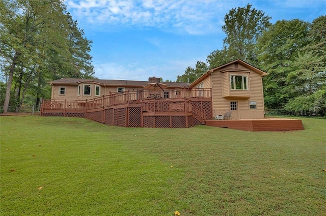 back of property featuring a yard and a deck