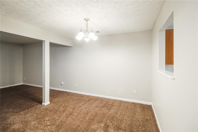 basement featuring a textured ceiling, carpet floors, and a notable chandelier