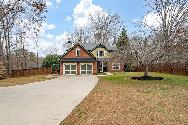 view of front of property with brick siding, fence, concrete driveway, a chimney, and a front yard