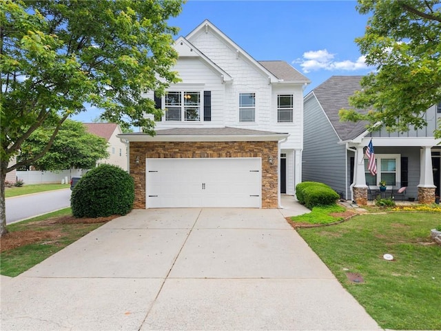 124 Oakmont Dr, Dawsonville, GA 30534 - craftsman house with stone siding, an attached garage, driveway, and a front yard