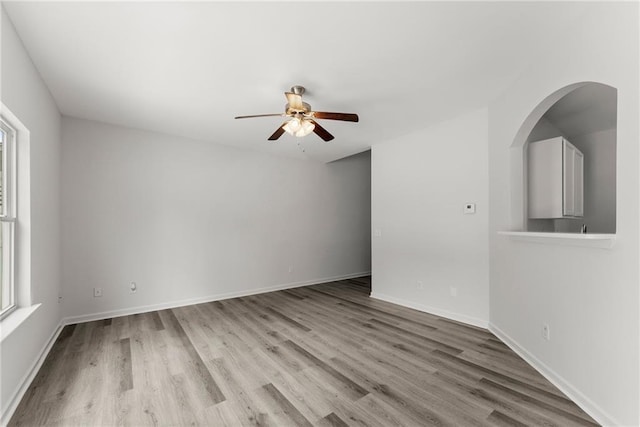 124 Oakmont Dr, Dawsonville, GA 30534 - unfurnished room with a ceiling fan, healthy amount of natural light, wood finished floors, and baseboards