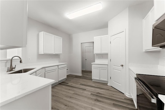 124 Oakmont Dr, Dawsonville, GA 30534 - kitchen with a sink, stainless steel microwave, black electric range oven, and white cabinetry
