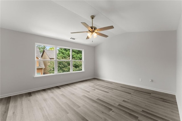 124 Oakmont Dr, Dawsonville, GA 30534 - spare room with vaulted ceiling, wood finished floors, ceiling fan, and baseboards