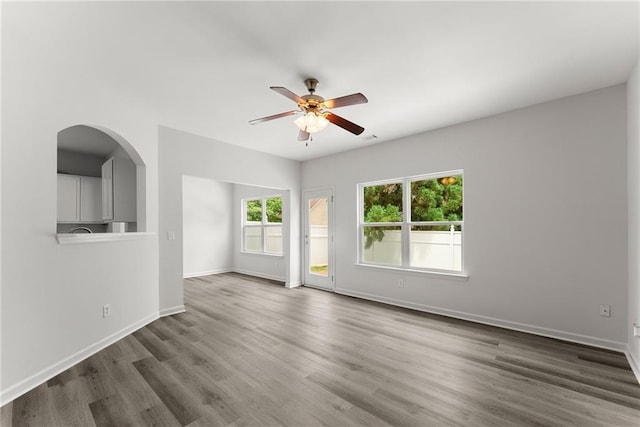 124 Oakmont Dr, Dawsonville, GA 30534 - unfurnished room with a ceiling fan, dark wood finished floors, baseboards, and arched walkways