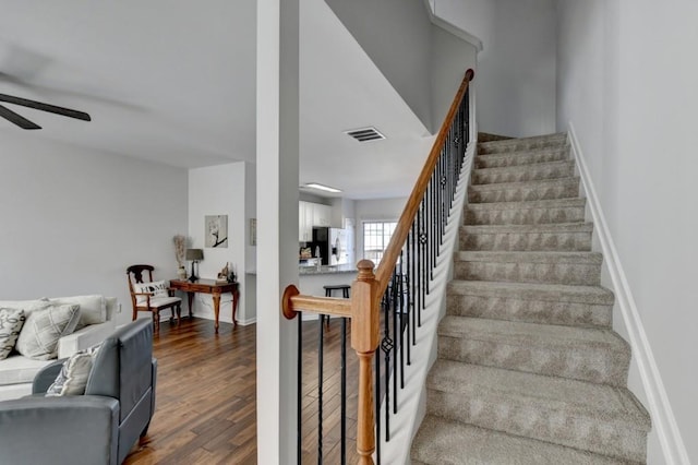 stairs with ceiling fan and wood-type flooring