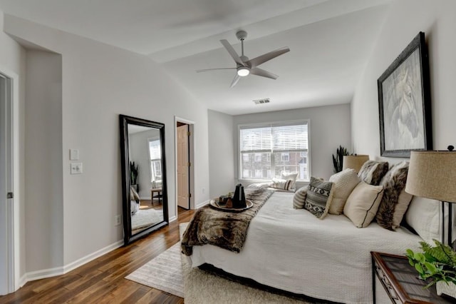 bedroom featuring ceiling fan, dark hardwood / wood-style flooring, and lofted ceiling